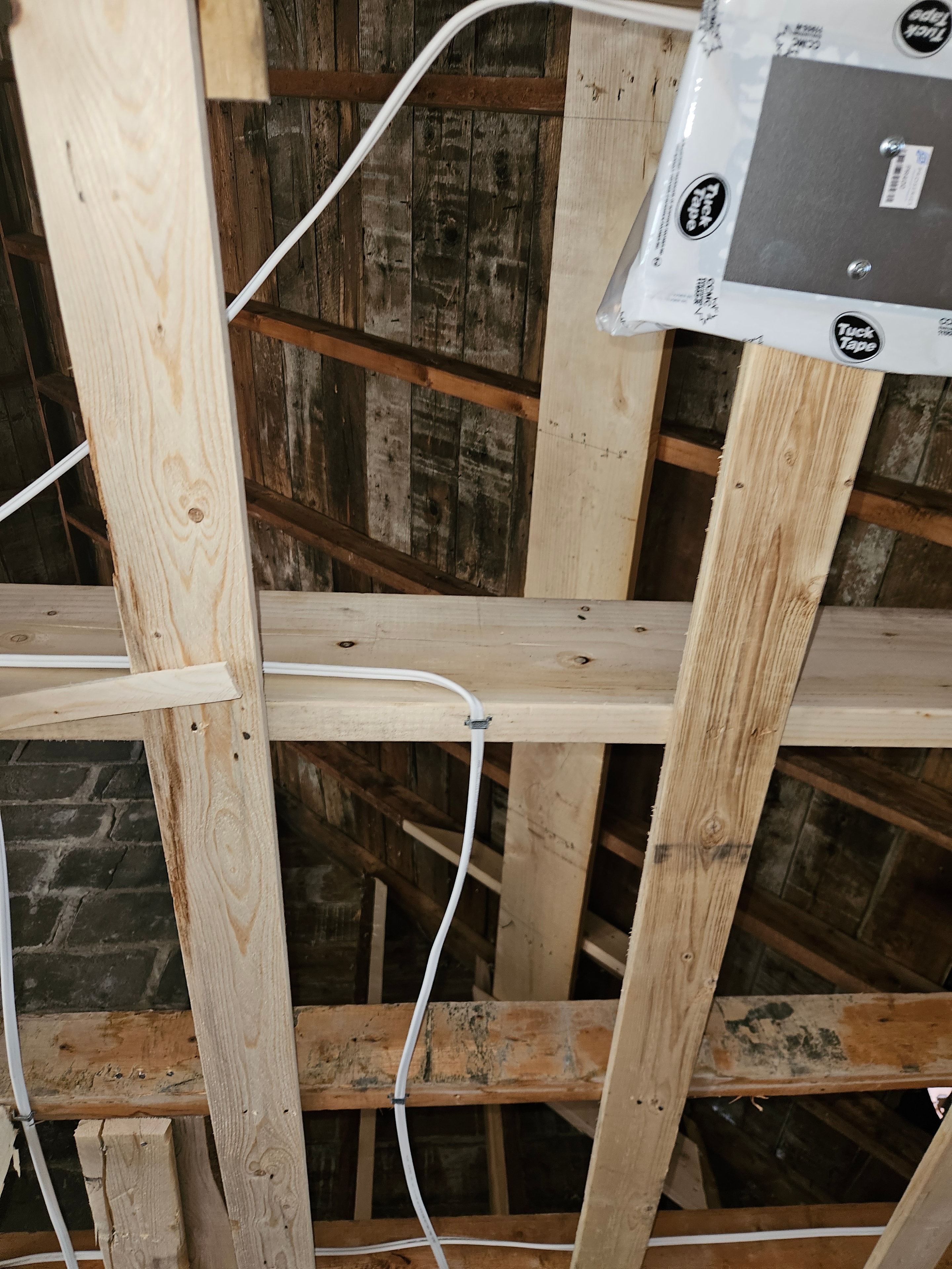 CT6 vent unit mounted in attic framing with loose duct run along rafters during full interior renovation